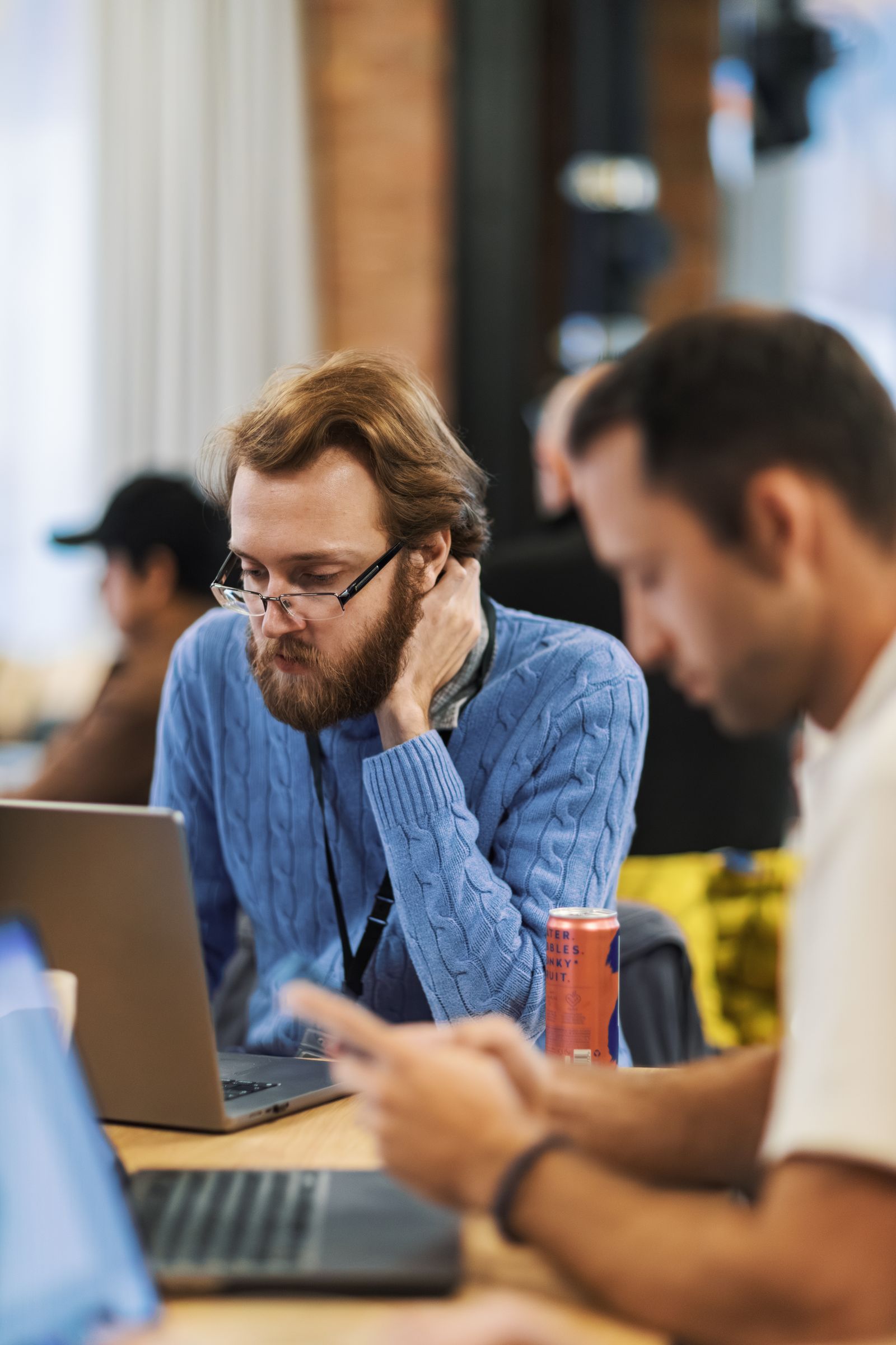 Technology professionals collaborating around computer screens